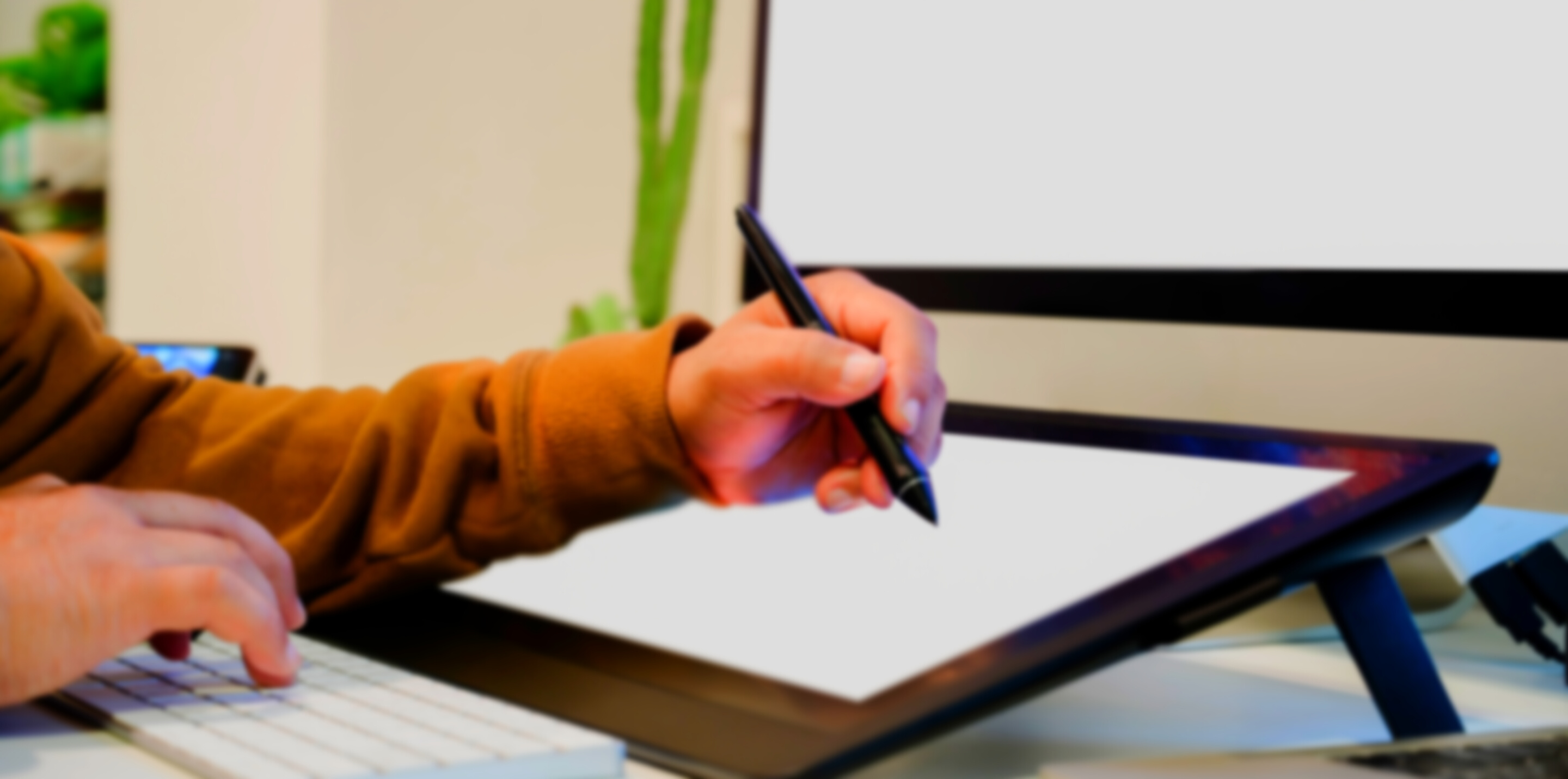 Designer drawing with stylus on graphic tablet